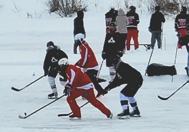 Teams compete in hockey action Feb. 13, 2021, during the Fort McCoy Pond Hockey Tournament on Big Sandy Lake on South Post at Fort McCoy, Wis. The tournament included eight teams from the post and local communities. There were also $1,280 in...