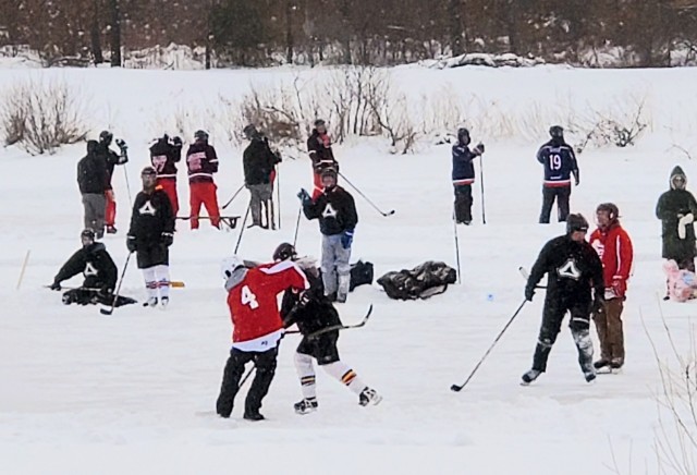 Teams compete in hockey action Feb. 13, 2021, during the Fort McCoy Pond Hockey Tournament on Big Sandy Lake on South Post at Fort McCoy, Wis. The tournament included eight teams from the post and local communities. There were also $1,280 in...