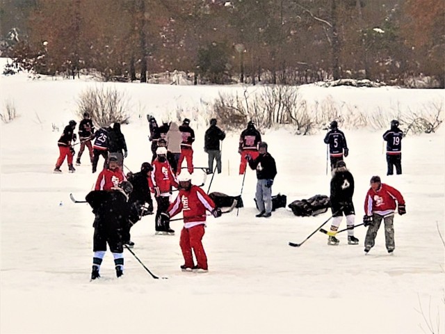 Teams compete in hockey action Feb. 13, 2021, during the Fort McCoy Pond Hockey Tournament on Big Sandy Lake on South Post at Fort McCoy, Wis. The tournament included eight teams from the post and local communities. There were also $1,280 in...