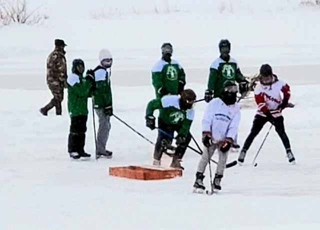 Teams compete in hockey action Feb. 13, 2021, during the Fort McCoy Pond Hockey Tournament on Big Sandy Lake on South Post at Fort McCoy, Wis. The tournament included eight teams from the post and local communities. There were also $1,280 in...