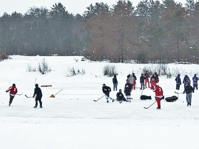 Teams compete in hockey action Feb. 13, 2021, during the Fort McCoy Pond Hockey Tournament on Big Sandy Lake on South Post at Fort McCoy, Wis. The tournament included eight teams from the post and local communities. There were also $1,280 in...