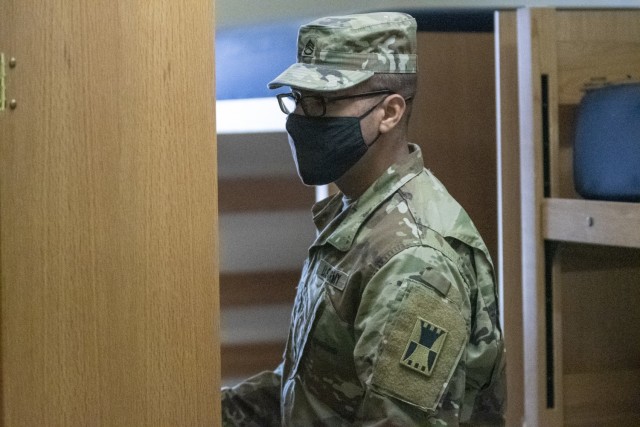 Staff Sgt. Nefty De La Rosa, OR-MTC base camp noncommissioned officer, inspects a wall locker during the clearing process near Camp McGregor, Fort Bliss, Texas, March 10, 2021.  The OR-MTC team is responsible for providing quality of life troop sustainment for units conducting mobilization validation certification training, and Pre-Mobilization/Exercise Training (PMET). (U.S. Army photo by Capt. Brandon Fambro)