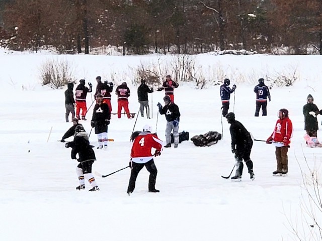 Teams compete in hockey action Feb. 13, 2021, during the Fort McCoy Pond Hockey Tournament on Big Sandy Lake on South Post at Fort McCoy, Wis. The tournament included eight teams from the post and local communities. There were also $1,280 in...
