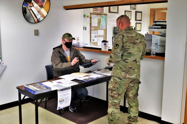 A Soldier prepares to sign in to receive the COVID-19 vaccine Feb. 26, 2021, at the Occupational Health Clinic at Fort McCoy, Wis. The clinic began providing COVID-19 shots in January 2021 and have continued the effort under a strict set of...