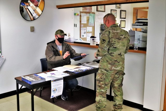 A Soldier prepares to sign in to receive the COVID-19 vaccine Feb. 26, 2021, at the Occupational Health Clinic at Fort McCoy, Wis. The clinic began providing COVID-19 shots in January 2021 and have continued the effort under a strict set of procedures that began with giving vaccinations to frontline and emergency services personnel. (U.S. Army Photo by Scott T. Sturkol, Public Affairs Office, Fort McCoy, Wis.)