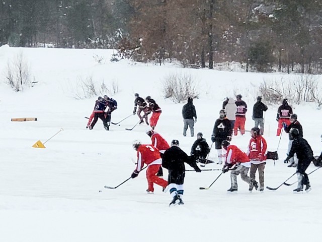 Teams compete in hockey action Feb. 13, 2021, during the Fort McCoy Pond Hockey Tournament on Big Sandy Lake on South Post at Fort McCoy, Wis. The tournament included eight teams from the post and local communities. There were also $1,280 in...