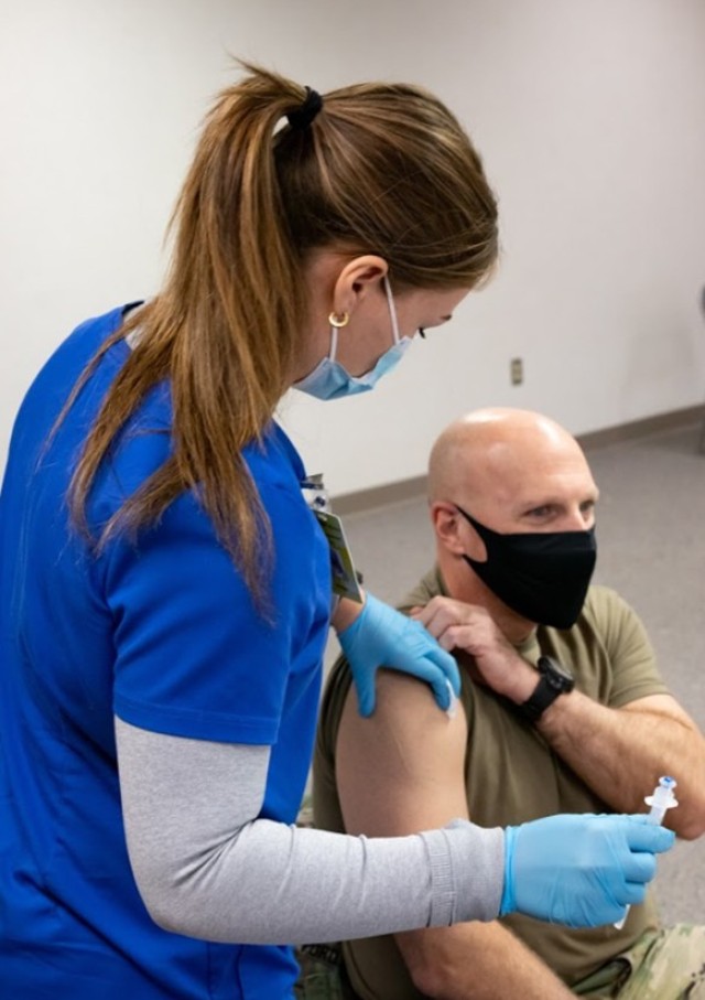Lt. Col, Warren Ford, Professor of Military Science for University of Central Oklahoma Army ROTC, prepares to receive his COVID vaccination from Cadet Morgan Scott, a nursing major and student in Ford’s Military Science IV class, March 5.