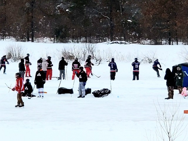 Teams compete in hockey action Feb. 13, 2021, during the Fort McCoy Pond Hockey Tournament on Big Sandy Lake on South Post at Fort McCoy, Wis. The tournament included eight teams from the post and local communities. There were also $1,280 in...