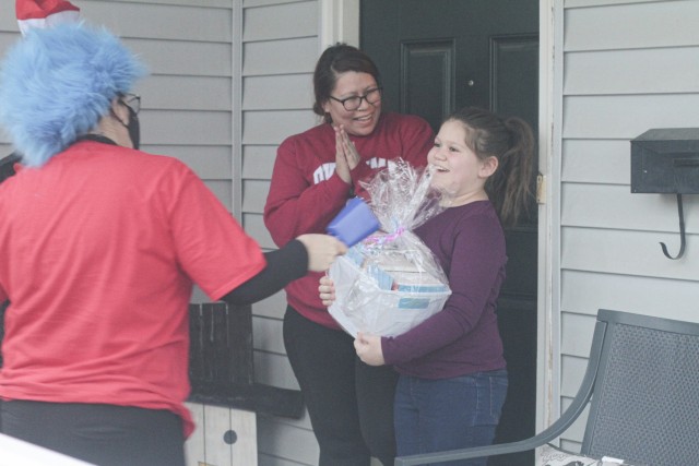 Kynlee Barber shouts with joy March 5 when her mom, Ashlee Beasley, opens the door for the Cat in the Hat and Thing 1. Barber is a third grade student at Andre Lucas Elementary School.