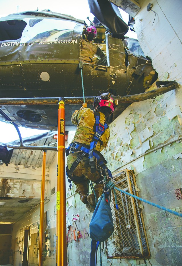 Spc. Vanessa Toro climbs into a helicopter as the 911th Engineering Techncial Rescue Company holds a competition for Rescuer of the Quarter at the Lorton Training Site, Feb. 25. The 911th is the only company of its kind in the Army.