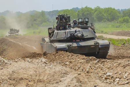 A pair of M1 Abrams tanks from 3rd Infantry Division's 1st Armored Brigade Combat Team roll along a dirt path after breaching an obstacle during an exercise at the Dagmar North Training Area, South Korea, June 1, 2018. Armored vehicles may see a larger role in the Indo-Pacific region as the U.S. Army competes with China, said Maj. Gen. Ross Coffman, director of the Next Generation Combat Vehicle Cross-Functional Team, during a virtual discussion with the Center for Strategic and International Studies March 10, 2021. 
