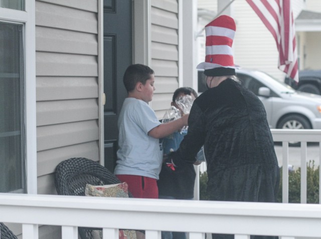 Braydon, left, and Hunter Bryant, accept a basket of books from the Cat in the Hat March 5 when the Prize Patrol Team from Andre Lucas Elementary School showed up at their house. Braydon is a third grade student, while his younger brother is in...