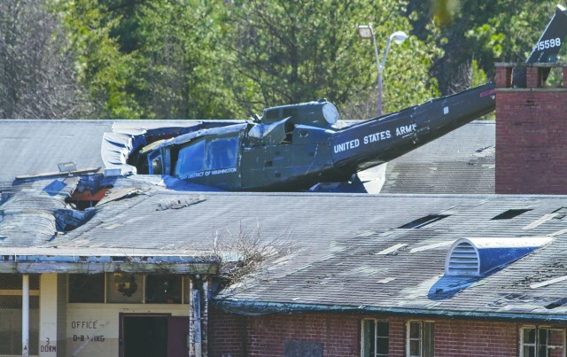 A Huey is lodged in the roof at the Lorton Training Site, which is one of many items at the Fairfax County Urban Search and Rescue location.