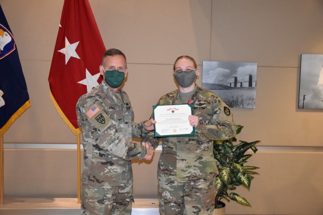 Sergeant 1st Class Abigail Keller, an operations noncommissioned-officer-in-charge with 1st Space Company, 1st Space Battalion, receives the Bronze Star from Lt. Gen. Daniel L. Karbler, commander, U.S. Space and Missile Defense Command, for her exceptionally meritorious service in combat zone with exposure to risk to hostile action in support of Combined Joint Task Force - Inherent Resolve, 2019-2020, at Peterson Air Force Base, Colo., Mar. 12. (Photo by Dottie K. White/RELEASED)