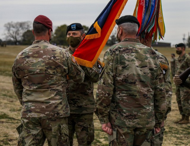 Major General JP McGee, incoming commanding general, 101st Airborne Division (Air Assault) and Fort Campbell, receives the division colors from Lt. Gen. Michael E. Kurilla, commanding general, XVIII Airborne Corps, and Maj. Gen. Brian E. Winski, outgoing commanding general, 101st Abn. Div. and Fort Campbell, March 5 during the division change of command at the division parade field.