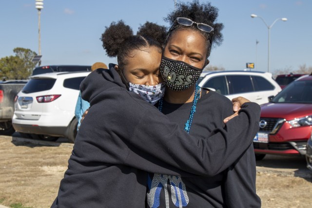 U.S. Army Soldier Sgt. 1st Class Jewel Lott, a colon cancer survivor and awareness organizer assigned to the 120th Infantry Brigade, Division West, takes a candid photo with her daughter Journey, after finishing a colon cancer awareness walk on March 6 at Lions Club Park, Killeen, Texas. While March is colon cancer awareness month, Lott has started a new journey of supporting her community by organizing an annual walk for colon cancer. (U.S. Army Reserve Reserve Photo by Staff Sgt. Erick Yates)
