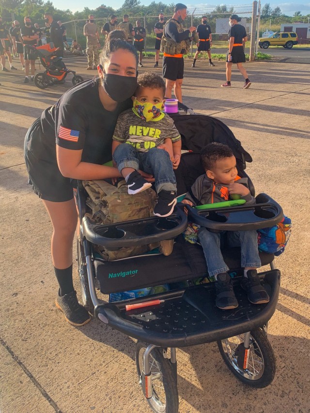 Spc. Kiala Nichols, an Aviation Operation Specialist (15P), assigned to 25th Combat Aviation Brigade, 25th Infantry Division at Wheeler Army Airfield, Hawaii, poses for photo after completing the 2021 8-Mile Great Aloha Run while pushing her two children in a double stroller and wearing her IOVT with plates and finishing first in her category. (Courtesy photo)