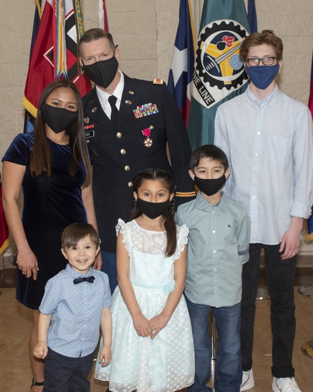 Chief Warrant Officer 4 Robert Dees, U.S. Army Sustainment Command, gathers for a family photo with his wife and children after the Quarterly Retirement Ceremony held at Rock Island Arsenal, Illinois, March 11. (Photo by Linda Lambiotte, ASC Public Affairs)