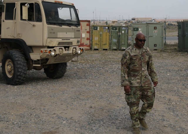 1st Sgt. Stephen E. Jones II, the top NCO at the Headquarters and Headquarters Company, 310th Sustainment Command (Expeditionary), acts as a ground guide March 1, 2021 in the company's motor yard at Camp Arifjan, Kuwait. Jones was in Kuwait as a private first class with 3rd Armored Division for service in the First Gulf War 30 years ago.