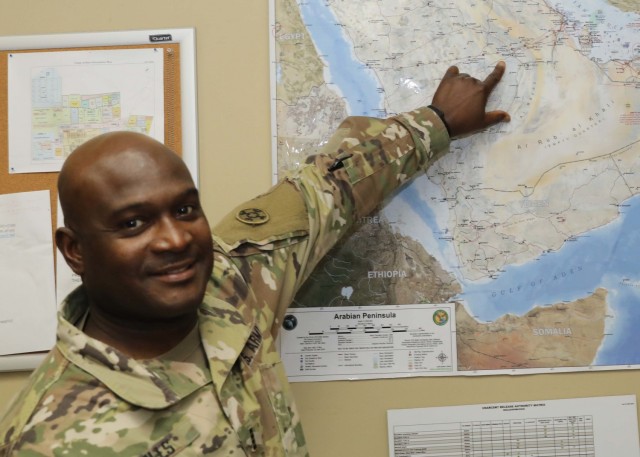 Army Reserve Chief Warrant Officer 4 Denrick Mills, 310th Sustainment Command (Expeditionary), now deployed to Camp Arifjan, Kuwait, March 1, 2021, points on the map to Riyadh, Saudi Arabia, where he was deployed as a specialist 30 years ago during the First Gulf War. Mills said it is strange that for his whole time in Desert Shield and Desert Storm, he never made it to Kuwait, but now he is in Kuwait with the 310th ESC.