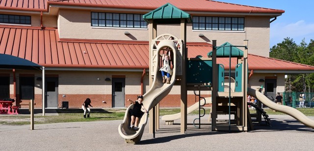 Madison Murphy waits at the top of the slide as Madison Moreno, reaches the bottom March 9 at the School Age Center.