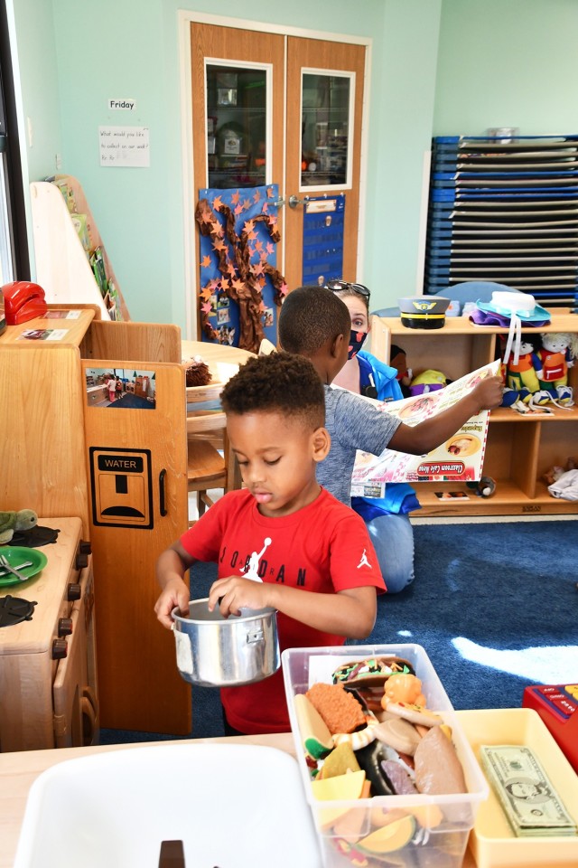 Kashton Summers, 4, seems to enjoy cooking a meal during playtime at Fort Polk CDC bldg 3349
