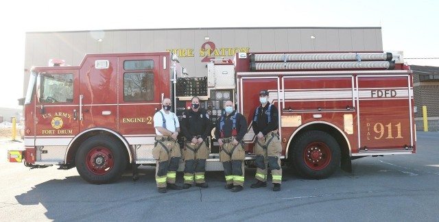 Capt. David Kuhl, Firefighter Timothy Newman, Firefighter David Egan, Firefighter Joseph Chaisson, all with Fort Drum Fire Station 2, stand in front of the new fire engine on March 15. (Photo by Mike Strasser, Fort Drum Garrison Public Affairs)