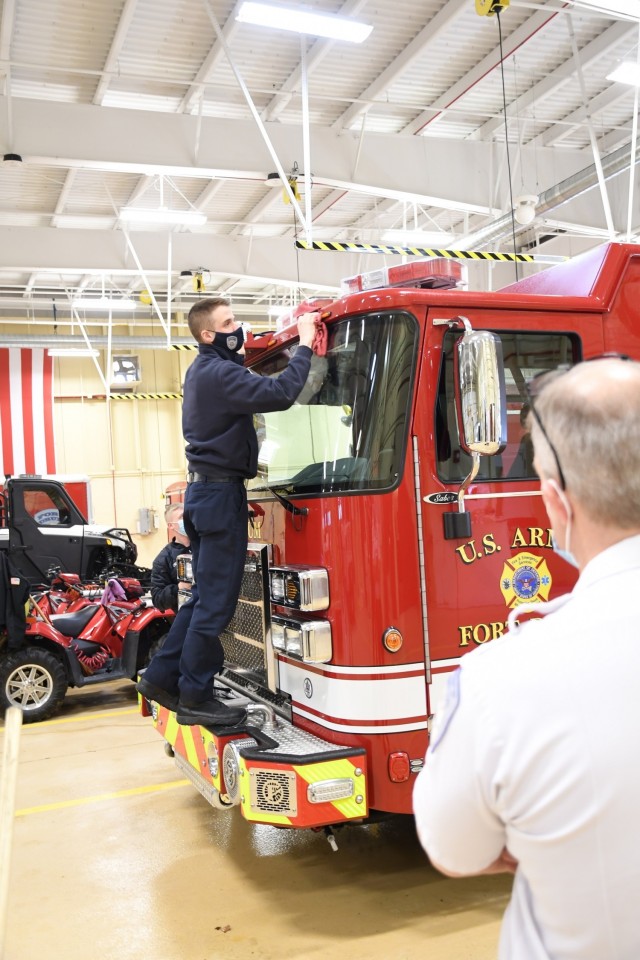 Fort Drum firefighters wash the new fire engine at Fire Station 2 on March 15. The apparatus features a 1,500 gallon-per-minute pump and six-person cab, which will enhance the capabilities of firefighters responding to an emergency. (Photo by Mike...