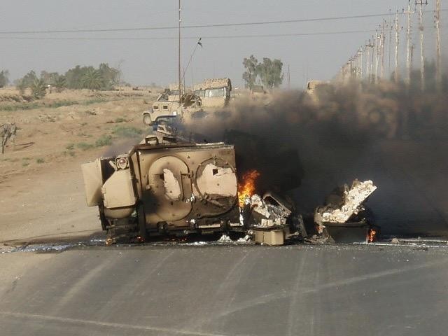 Then Staff Sgt. Curtis Reid's Bradley Fighting Vehicle burns after an explosively formed penetrator struck it southeast of Baghdad, Iraq, July 3rd, 2006. Reid, now a command sergeant major with 1st Battalion, 28th Infantry Regiment, 3rd Infantry...