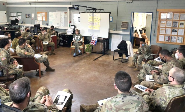 Laura Roman, U.S. Army Garrison Rheinland-Pfalz Army Substance Abuse Program Risk Reduction coordinator, talks with members of a unit about dealing with the grief they can expect after losing two fellow Soldiers to suicide in late 2020.