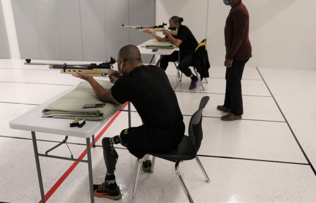 U.S. Army Staff Sgt. Gene Calantoc, and Master Sgt. Mary Jackson, Soldier Recovery Unit, Brooke Army Medical Center, shoot for record during the Virtual Army Trials air rifle event at Cole High School, Fort Sam Houston, Texas, March 4, 2021. Both...