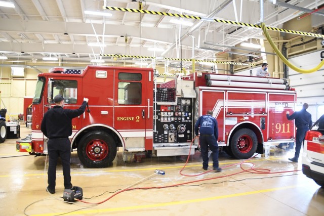 Fort Drum firefighters wash the new fire engine at Fire Station 2 on March 15. The apparatus features a 1,500 gallon-per-minute pump and six-person cab, which will enhance the capabilities of firefighters responding to an emergency. (Photo by Mike...