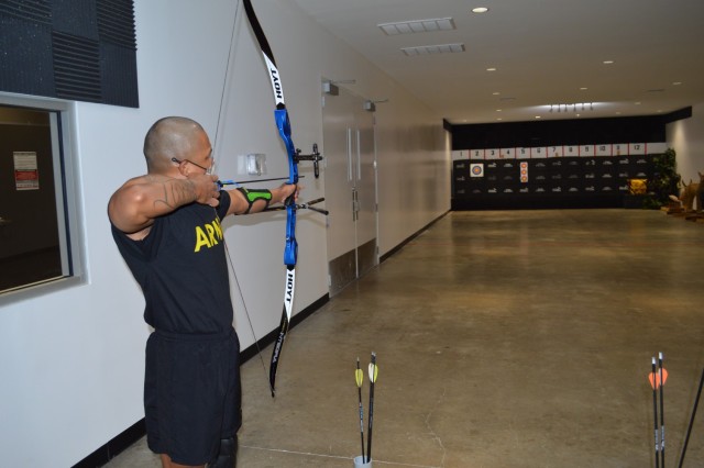 U.S. Army Staff Sgt. Gene Calantoc, a member of the Soldier Recovery Unit at Brooke Army Medical Center, prepares to loose an arrow during the Virtual Army Trials archery event held at Buck and Doe’s Mercantile in San Antonio, Texas, March 10,...