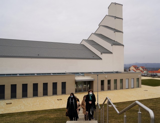 The tour travels from the Netzaberg Chapel, in the backdrop, to the out-of-view child development center, March 11, 2021.