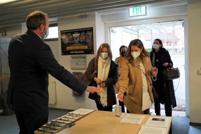Military spouses of several senior ranking officials are greeted by MPD Chief Robert Reed, while they use the hand sanitizer station at the USAG Bavaria Welcome Center, March 11, 2021.