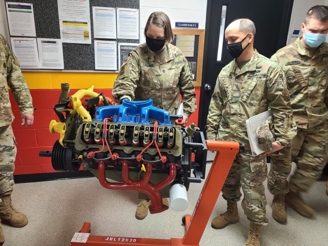 Command Sgt. Maj. Petra M. Casarez and Chief Warrant Officer 5 Danny K. Taylor check out the static engine display used during basic and advanced level Wheeled Vehicle Mechanic (91B10/30) courses at RTS-M, Fort Bragg.