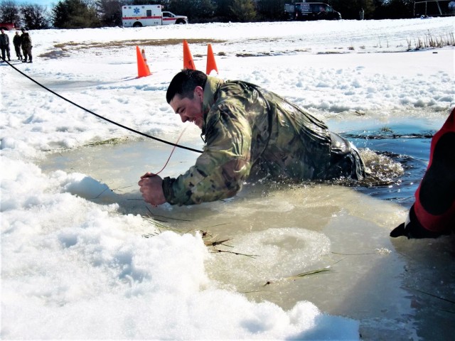 A Fort McCoy Cold-Weather Operations Course (CWOC) Class 21-04 student participates in cold-water immersion training Feb. 26, 2021, at Big Sandy Lake on South Post at Fort McCoy, Wis. CWOC students are trained on a variety of cold-weather...