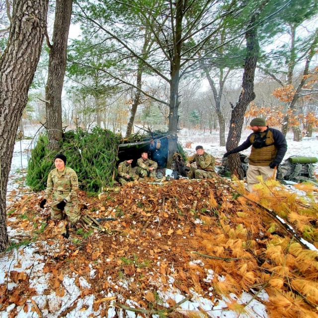 Students in Cold-Weather Operations Course class 21-05 conduct field training with improvised shelters March 16, 2021, at a training area at Fort McCoy, Wis. CWOC students are trained on a variety of cold-weather subjects, including snowshoe...