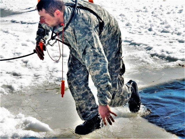 A Fort McCoy Cold-Weather Operations Course (CWOC) Class 21-04 student participates in cold-water immersion training Feb. 26, 2021, at Big Sandy Lake on South Post at Fort McCoy, Wis. CWOC students are trained on a variety of cold-weather...
