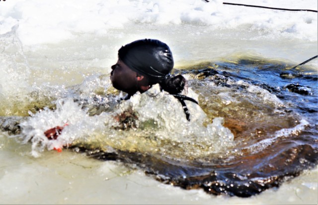 A Fort McCoy Cold-Weather Operations Course (CWOC) Class 21-04 student participates in cold-water immersion training Feb. 26, 2021, at Big Sandy Lake on South Post at Fort McCoy, Wis. CWOC students are trained on a variety of cold-weather...