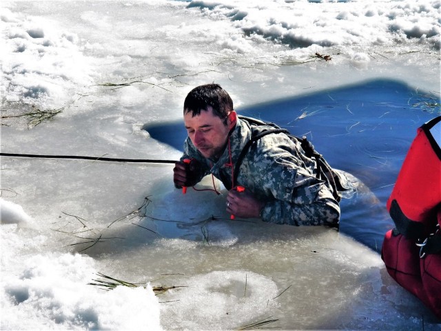 A Fort McCoy Cold-Weather Operations Course (CWOC) Class 21-04 student participates in cold-water immersion training Feb. 26, 2021, at Big Sandy Lake on South Post at Fort McCoy, Wis. CWOC students are trained on a variety of cold-weather...