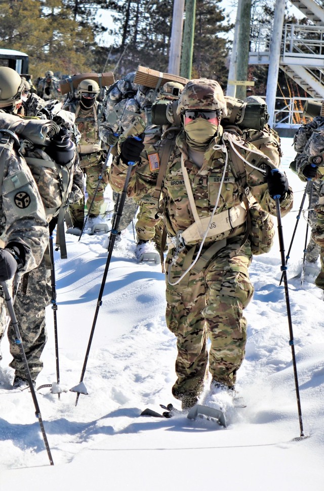 Students in Cold-Weather Operations Course class 21-04 complete field training pulling ahkio sleds of equipment on snowshoes Feb. 18, 2021, at a training area at Fort McCoy, Wis. Students complete many miles of ruck marching in the snow and cold...