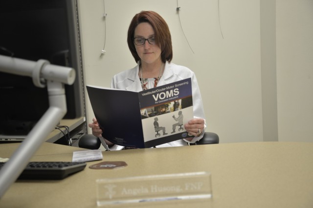 Angela Husong, a nurse practitioner with General Leonard Wood Army Community Hospital, reads the vestibular/ocular-motor screening checklist prior to a consultation at the GLWACH Traumatic Brain Injury clinic March 12.