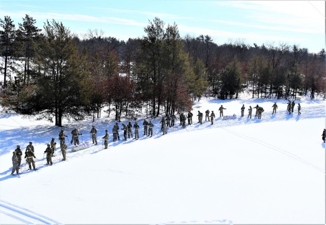 Students in Cold-Weather Operations Course class 21-04 complete field training pulling ahkio sleds of equipment on snowshoes Feb. 18, 2021, at a training area at Fort McCoy, Wis. Students complete many miles of ruck marching in the snow and cold...