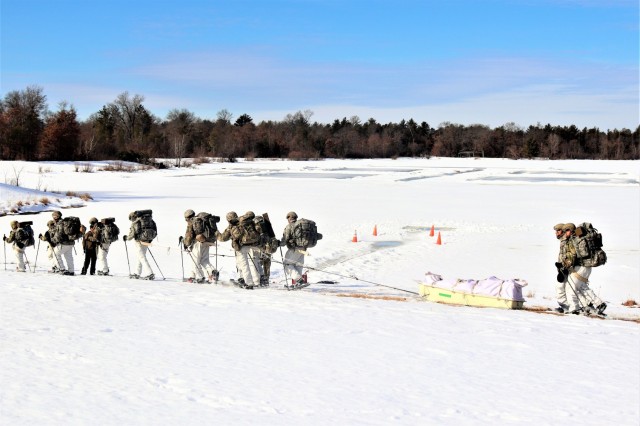 Students in Cold-Weather Operations Course class 21-04 complete field training pulling ahkio sleds of equipment on snowshoes Feb. 26, 2021, at a training area at Fort McCoy, Wis. Students complete many miles of ruck marching in the snow and cold...