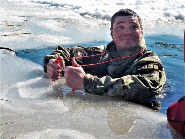 A Fort McCoy Cold-Weather Operations Course (CWOC) Class 21-04 student participates in cold-water immersion training Feb. 26, 2021, at Big Sandy Lake on South Post at Fort McCoy, Wis. CWOC students are trained on a variety of cold-weather...