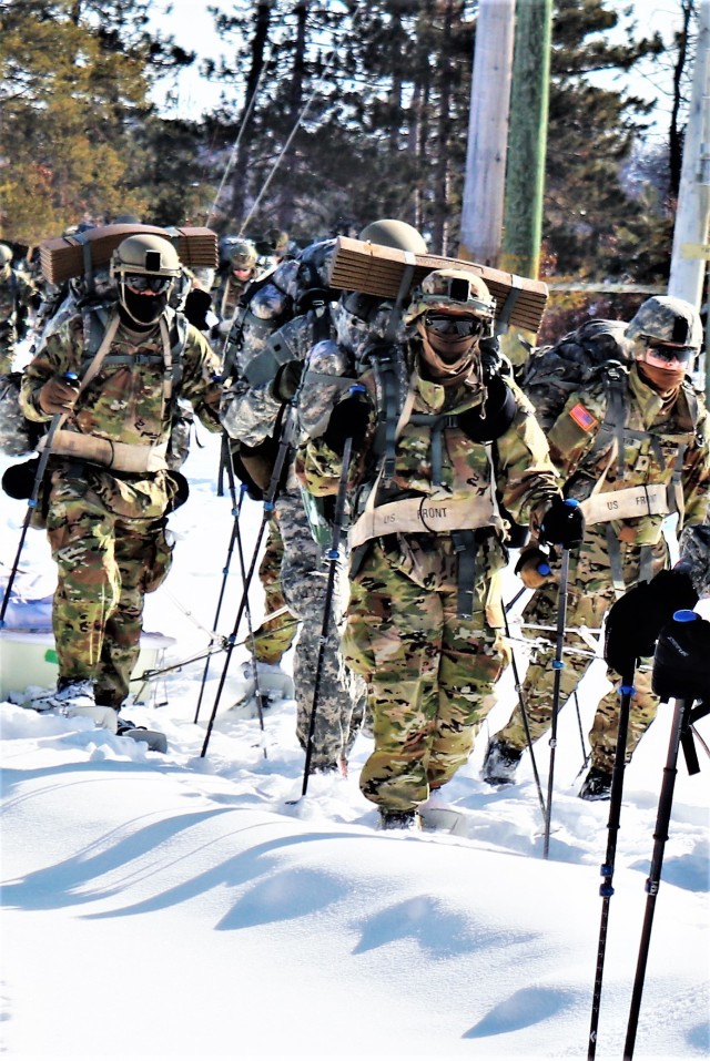 Students in Cold-Weather Operations Course class 21-04 complete field training pulling ahkio sleds of equipment on snowshoes Feb. 18, 2021, at a training area at Fort McCoy, Wis. Students complete many miles of ruck marching in the snow and cold...