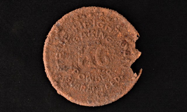 The rusted lid of a container of baking powder is shown Oct. 27, 2015. The artifact was discovered at a Fort McCoy, Wis., archaeological site in 2014. The lid dates from the 1930s-1950s. (Contributed photo)