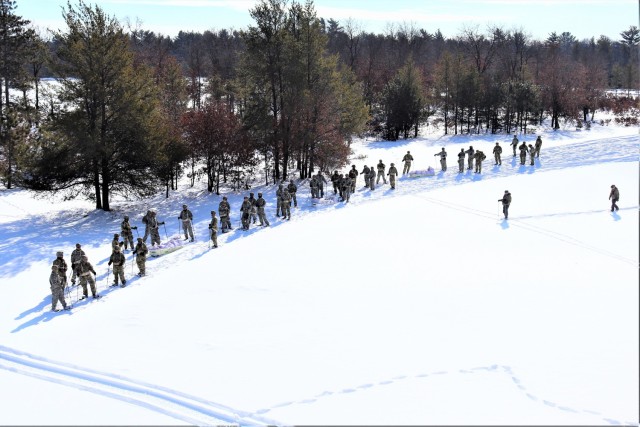 Students in Cold-Weather Operations Course class 21-04 complete field training pulling ahkio sleds of equipment on snowshoes Feb. 18, 2021, at a training area at Fort McCoy, Wis. Students complete many miles of ruck marching in the snow and cold...