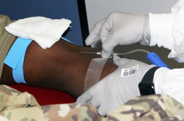 A laboratory technician with the Armed Services Blood Program inserts a needle in the arm of a donor assigned to 5th Armored Brigade, First Army Division West, during a blood drive event on Fort Bliss, Texas, May 16, 2021. Blood drive events are important because they provide quality blood products for service members, veterans and their families in both peace and war. For 5th AR BDE, preparing Soldiers to go into harm’s way isn’t merely a cold, mechanical process; rather, it’s a dedication to individuals’ strengths and needs, focused on achieving the mission. (U.S. Army photo by Staff Sgt. John Onuoha, 5th Armored Brigade)
